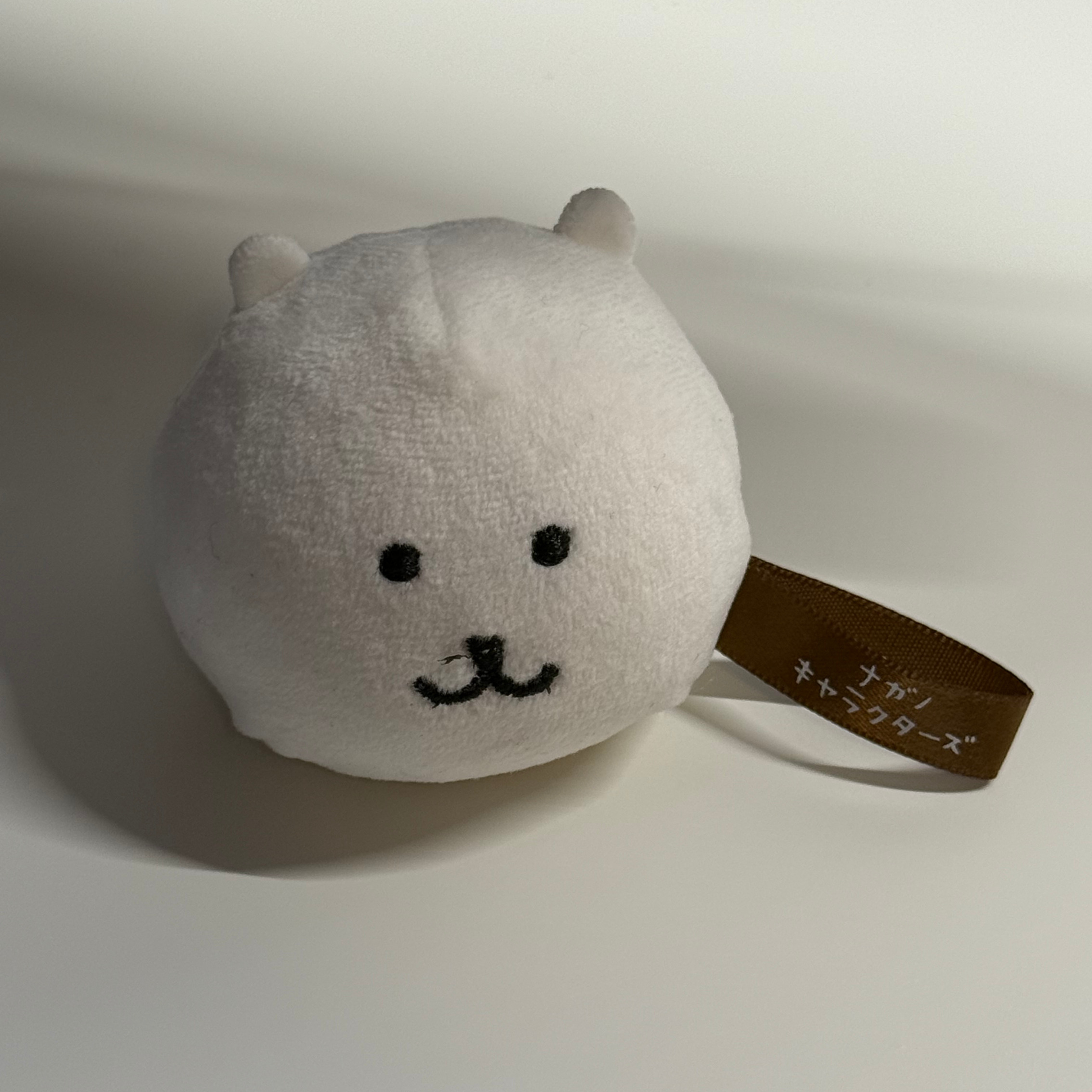 Front three-quarter view of the white plush toy