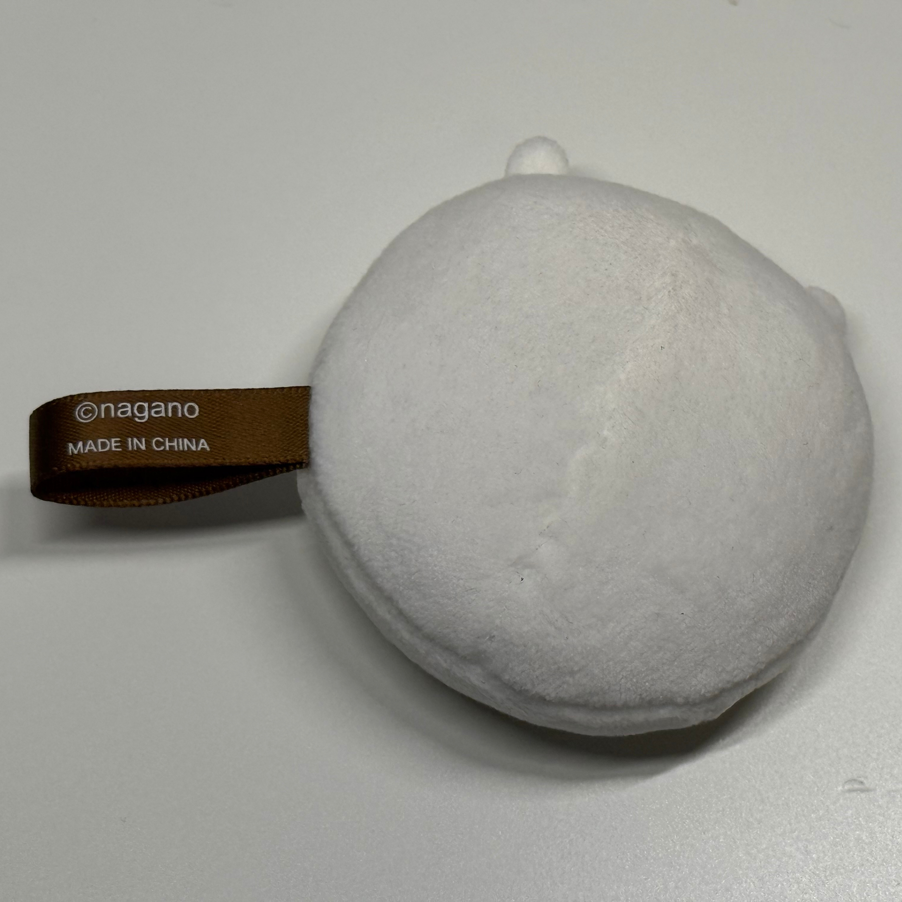 Back view of the plush toy showing its fabric tag